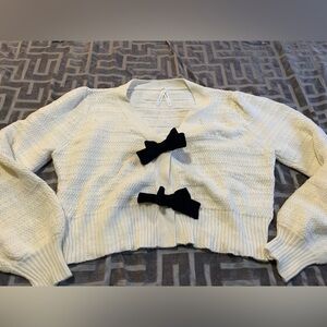 Elegant Cream Sweater with Black Bow Accents